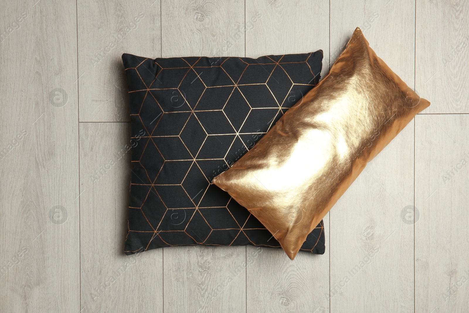 Photo of Soft decorative pillows on wooden background, top view