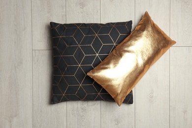 Photo of Soft decorative pillows on wooden background, top view