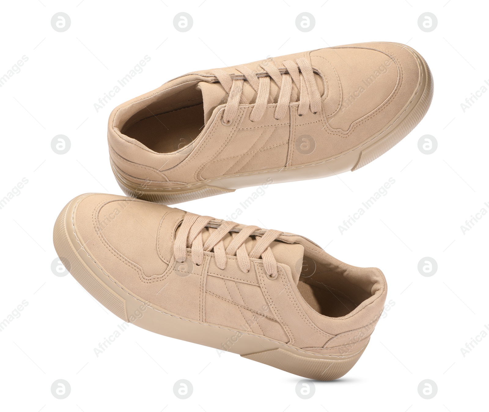 Photo of Pair of stylish beige sneakers isolated on white