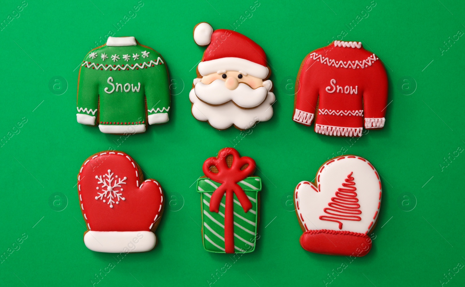 Photo of Different Christmas gingerbread cookies on green background, flat lay