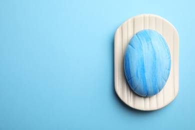 Photo of Holder with soap bar on color background, top view. Space for text
