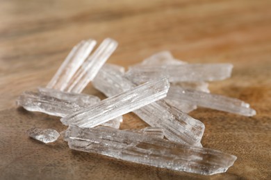 Menthol crystals on wooden background, closeup view