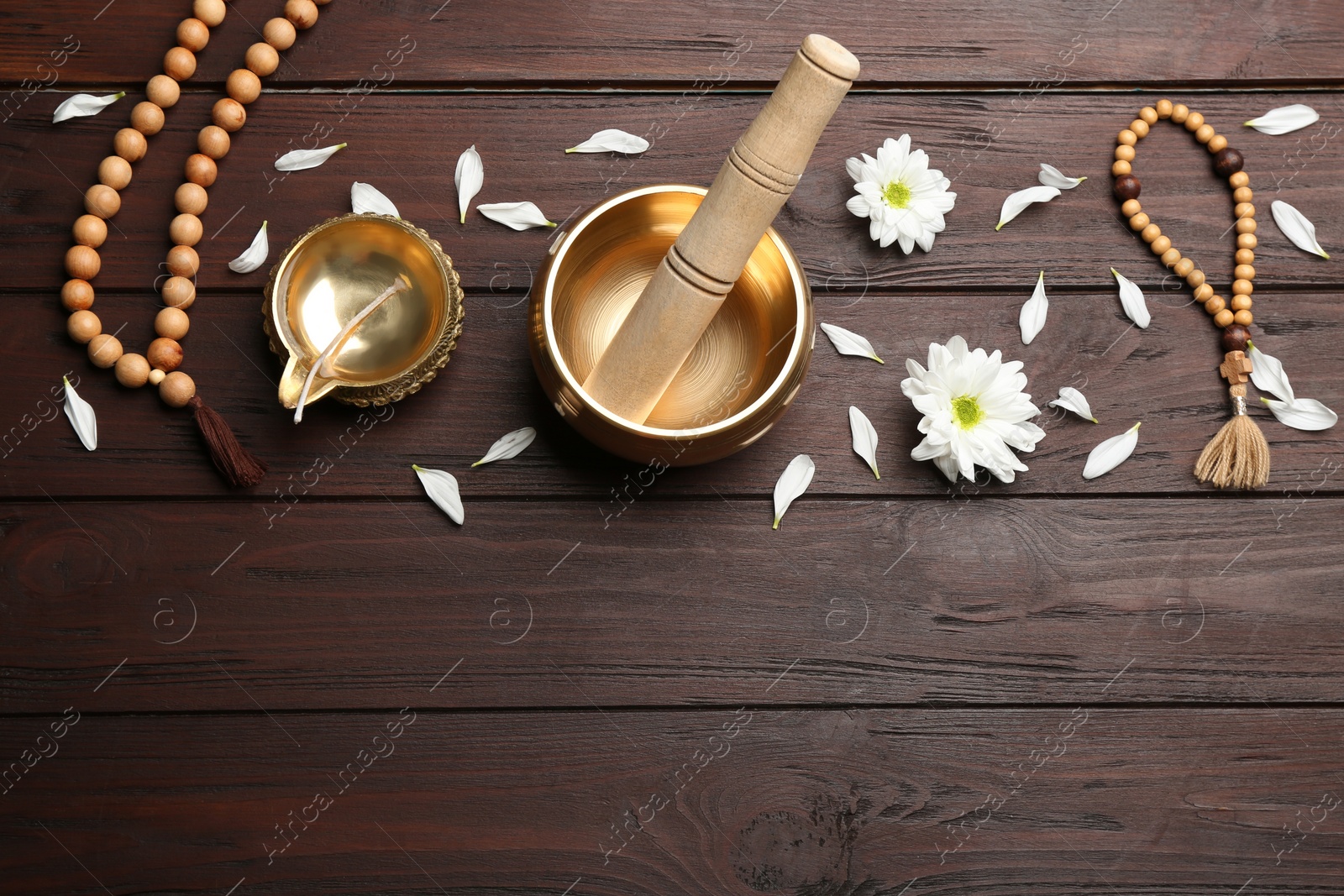 Photo of Flat lay composition with golden singing bowl on wooden table, space for text. Sound healing