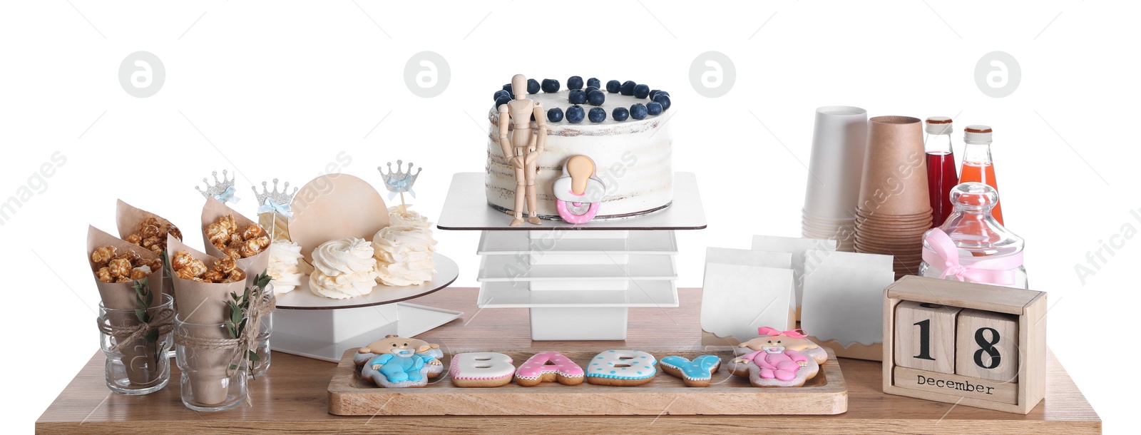 Photo of Baby shower party. Different delicious treats and decor on wooden table against white background