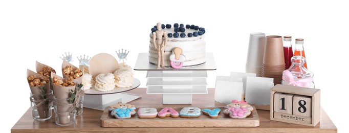 Photo of Baby shower party. Different delicious treats and decor on wooden table against white background