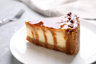 Piece of delicious cake with caramel on table, closeup