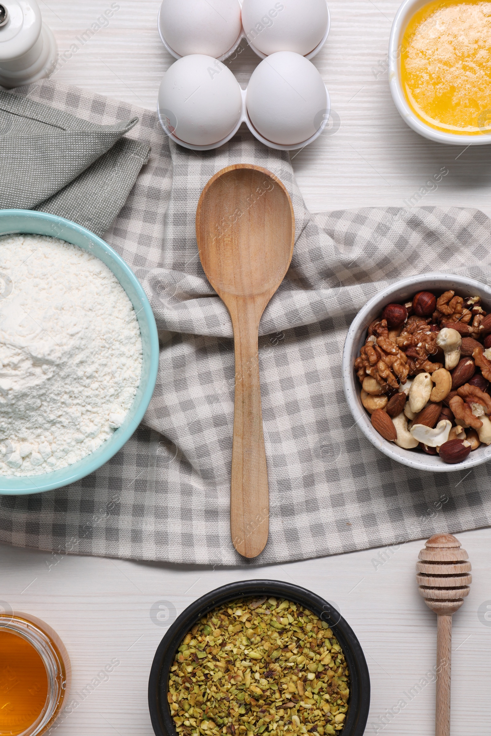 Photo of Different ingredients for making delicious baklava on white wooden table, flat lay