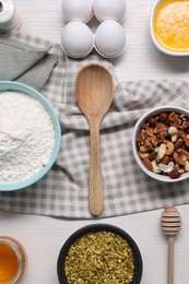 Different ingredients for making delicious baklava on white wooden table, flat lay