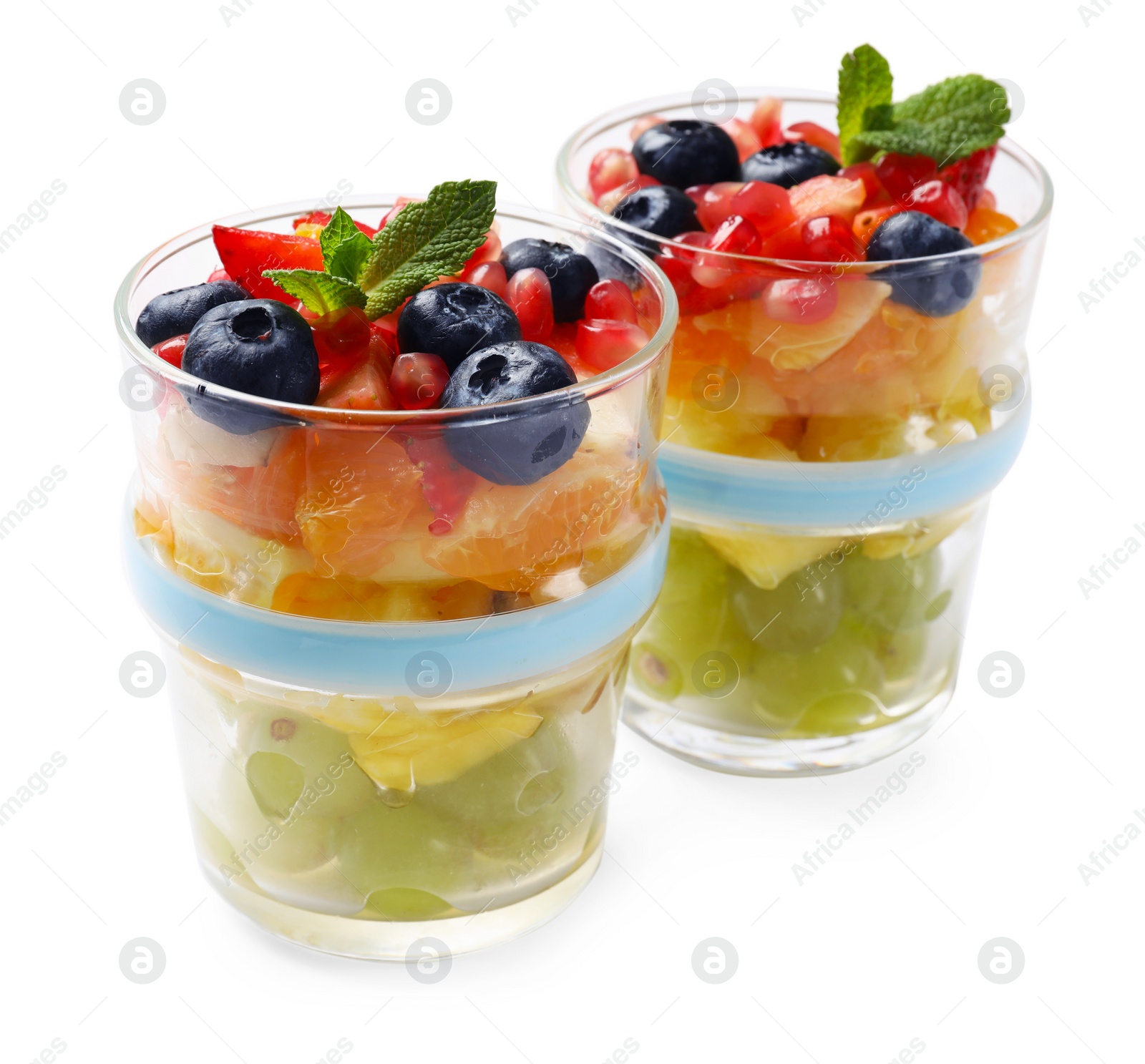 Photo of Delicious fruit salad in glasses isolated on white