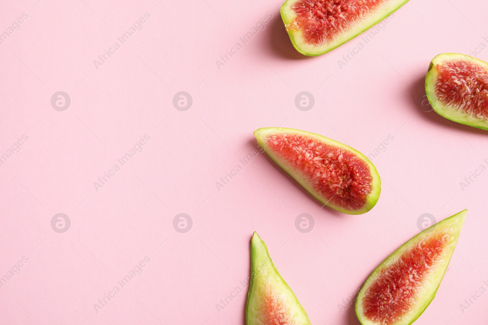 Photo of Fresh ripe fig slices on color background, top view. Space for text