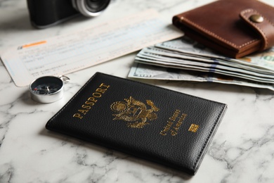 Photo of Composition with passport, compass and money on marble table. Travel agency