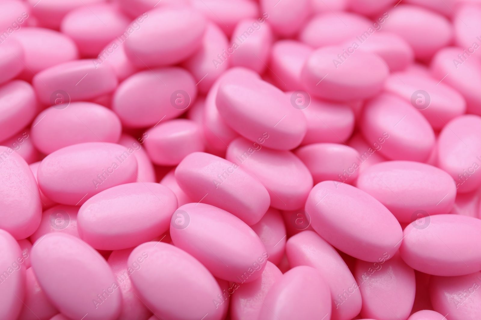 Photo of Many pink dragee candies as background, closeup