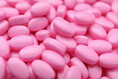 Photo of Many pink dragee candies as background, closeup