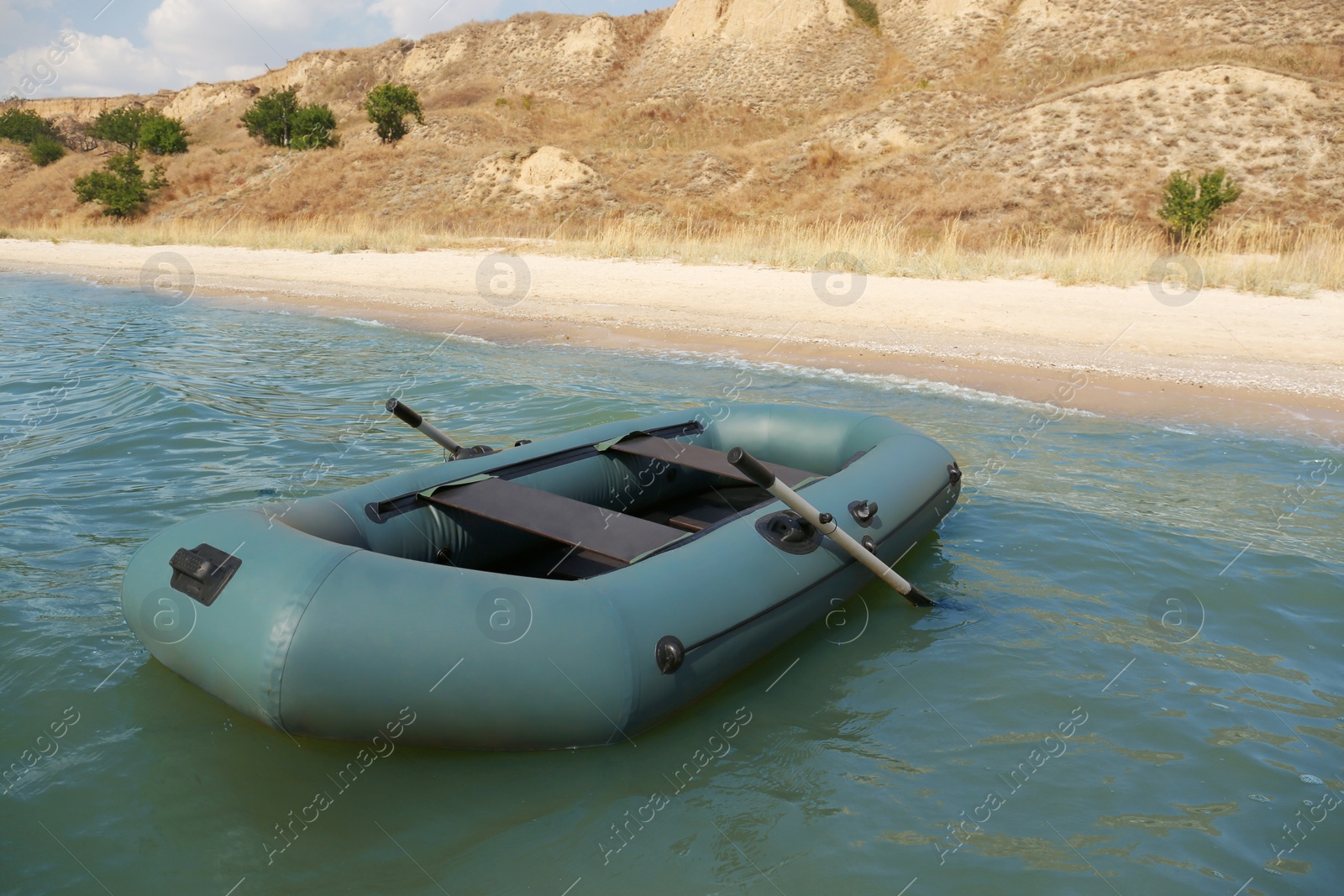 Photo of Inflatable rubber fishing boat floating in sea near coast