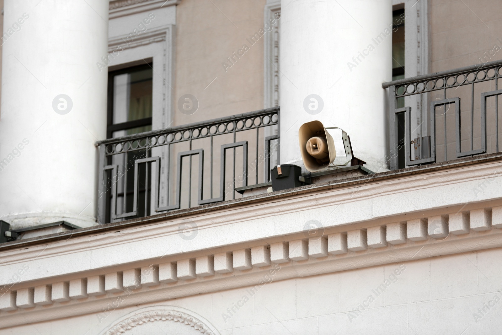 Photo of Retro megaphone on old building. Space for text
