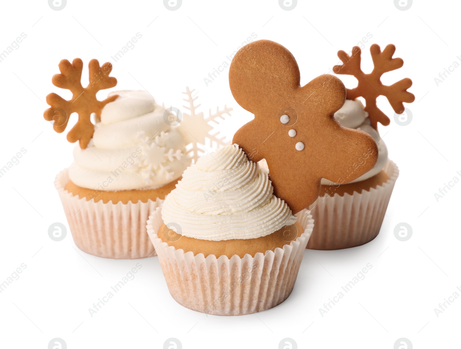 Photo of Tasty Christmas cupcakes with gingerbread man and snowflakes on white background