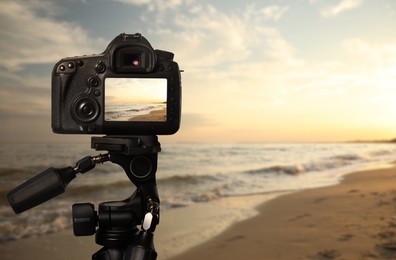 Image of Taking photo of beautiful seascape with camera mounted on tripod