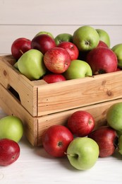 Photo of Fresh ripe red and green apples on white wooden table