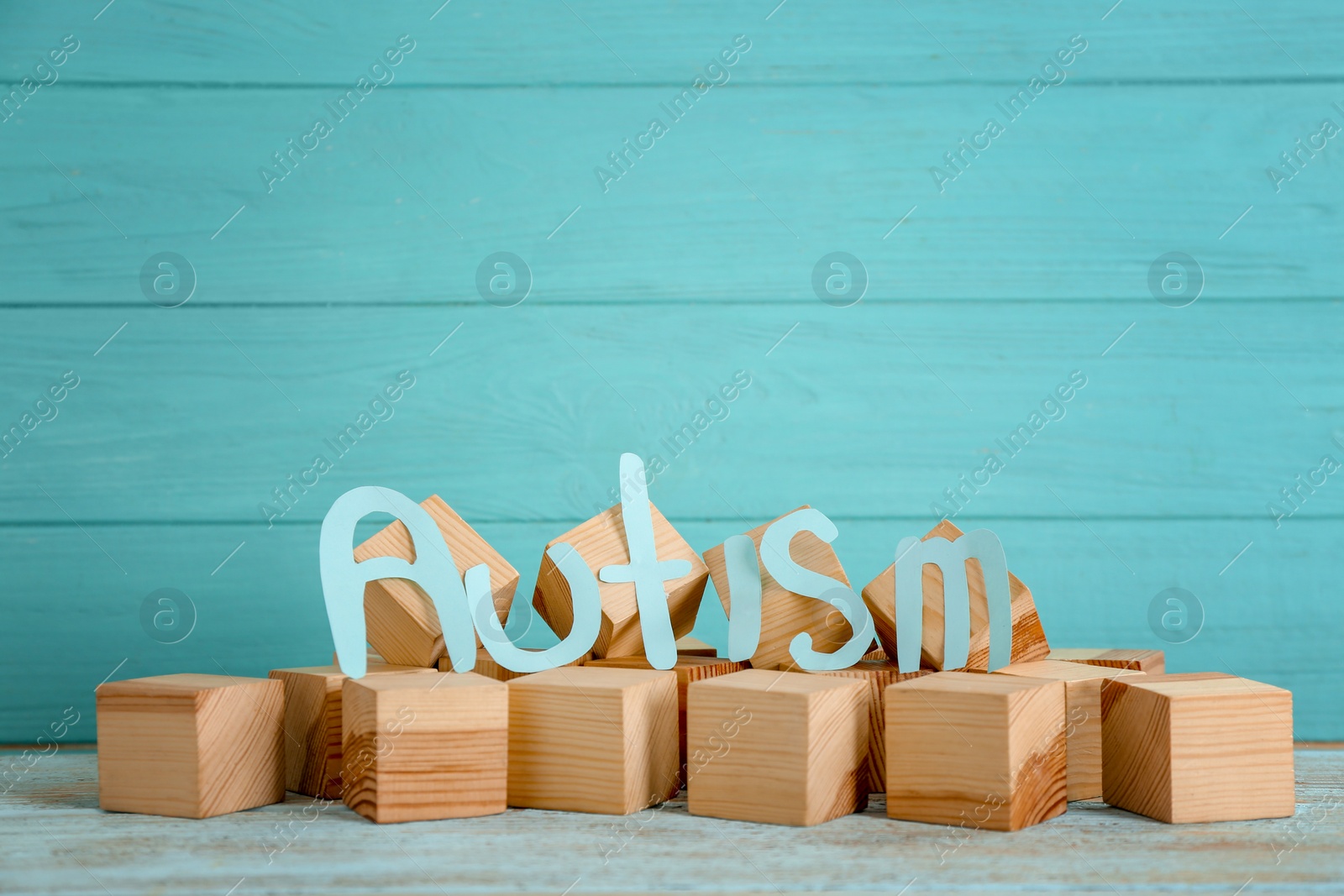 Photo of Word "Autism" and wooden cubes on table