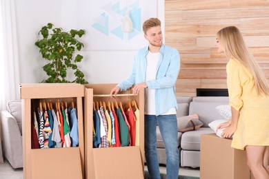 Young couple near wardrobe boxes at home