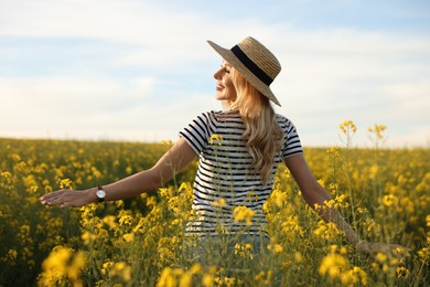 Photo of Happy young woman with straw hat in field on spring day