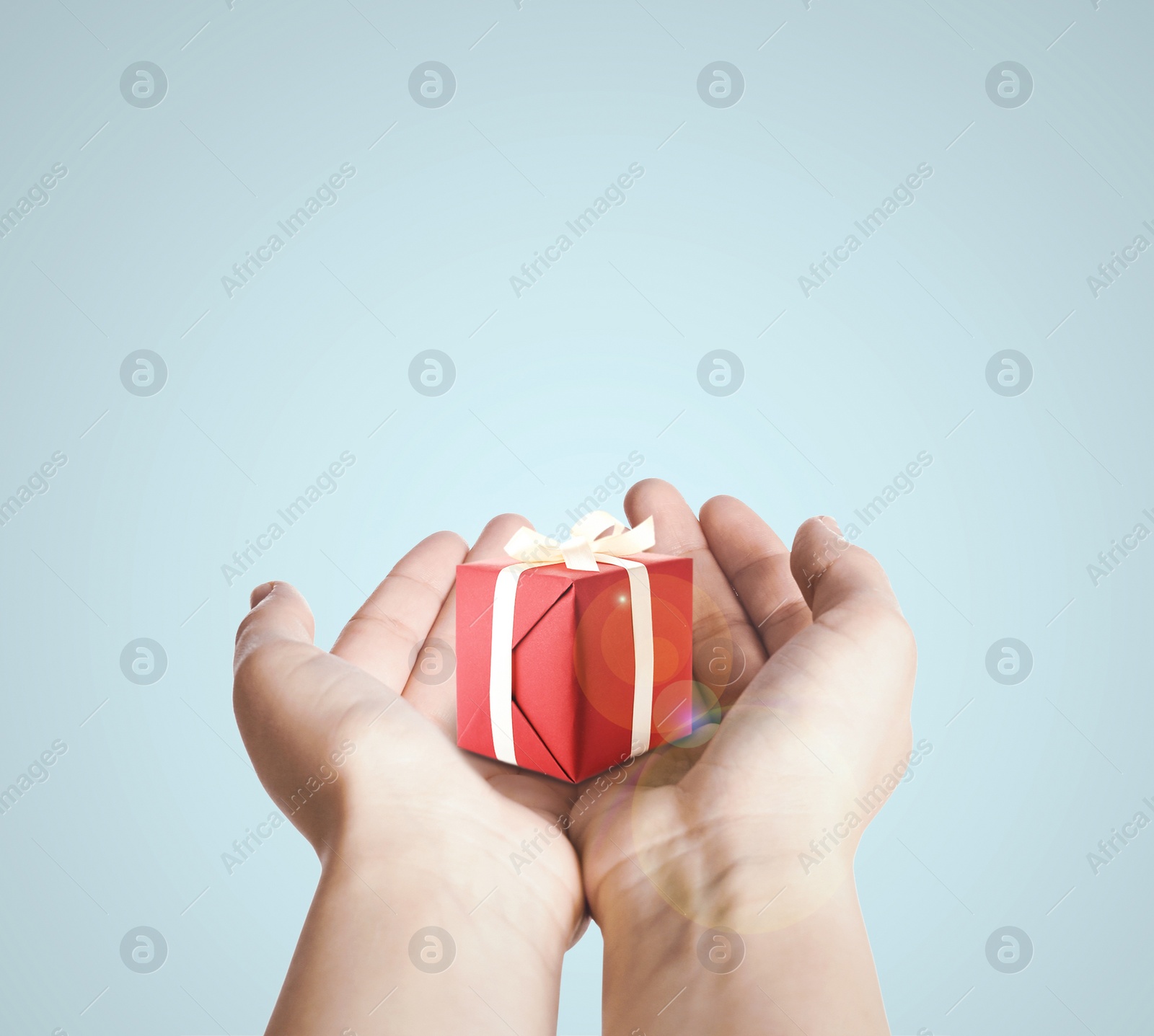 Image of Boxing day. Woman with gift on light background, closeup 