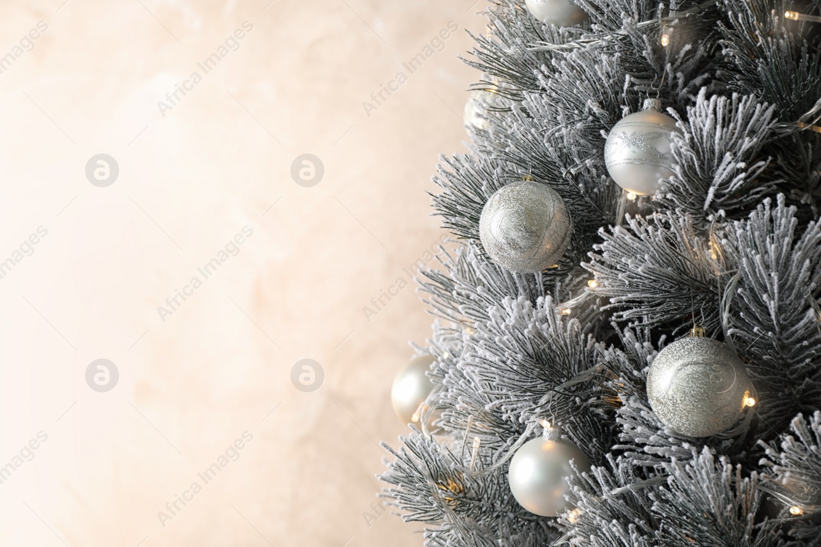 Photo of Beautiful Christmas tree with decor on light background. Space for text