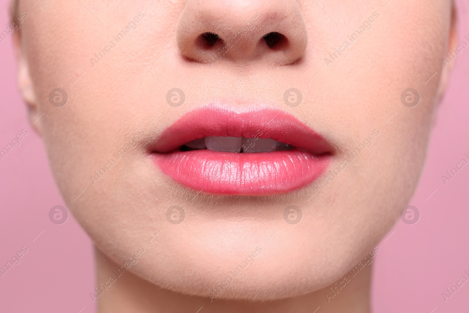 Photo of Beautiful young woman with perfect lips makeup on color background, closeup