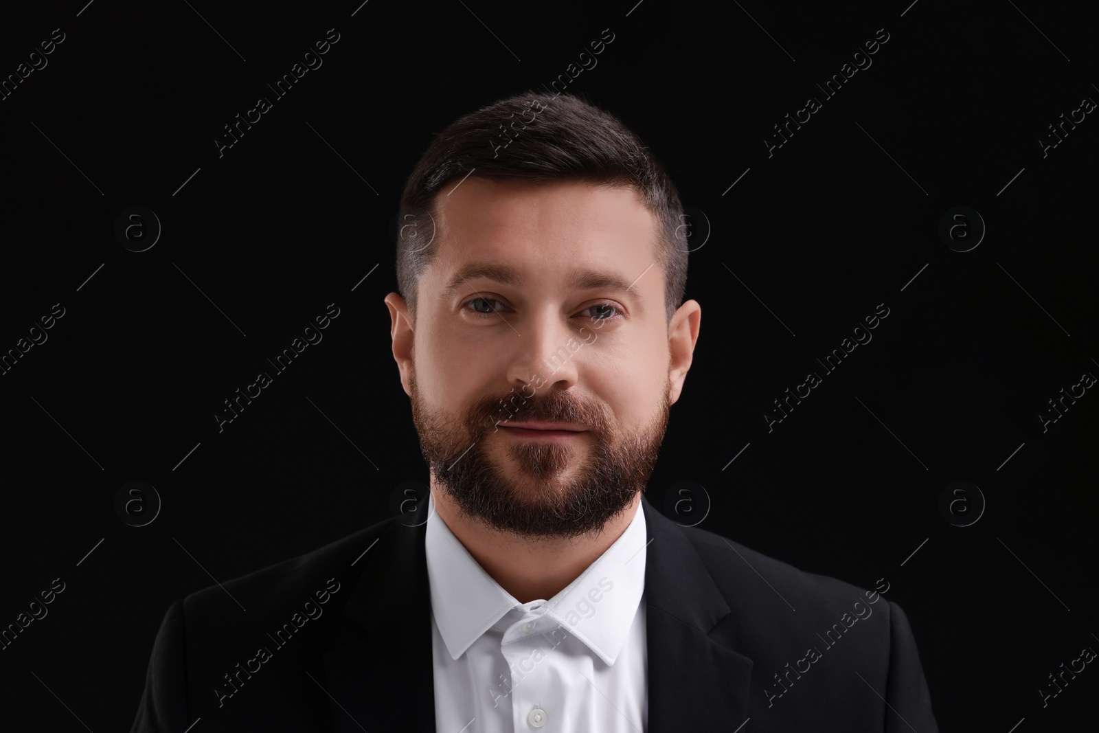 Photo of Personality concept. Portrait of handsome man on black background