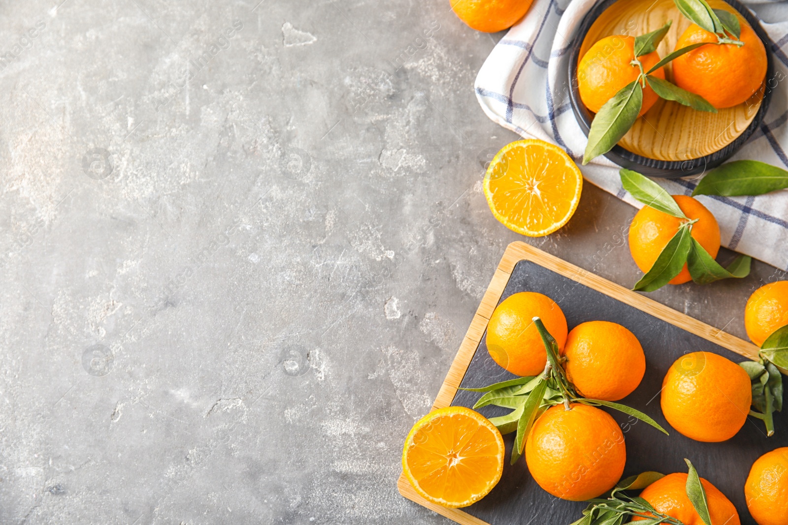 Photo of Flat lay composition with ripe tangerines on grey background. Space for text