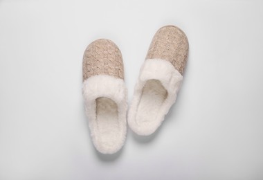 Photo of Pair of beautiful soft slippers on white background, top view