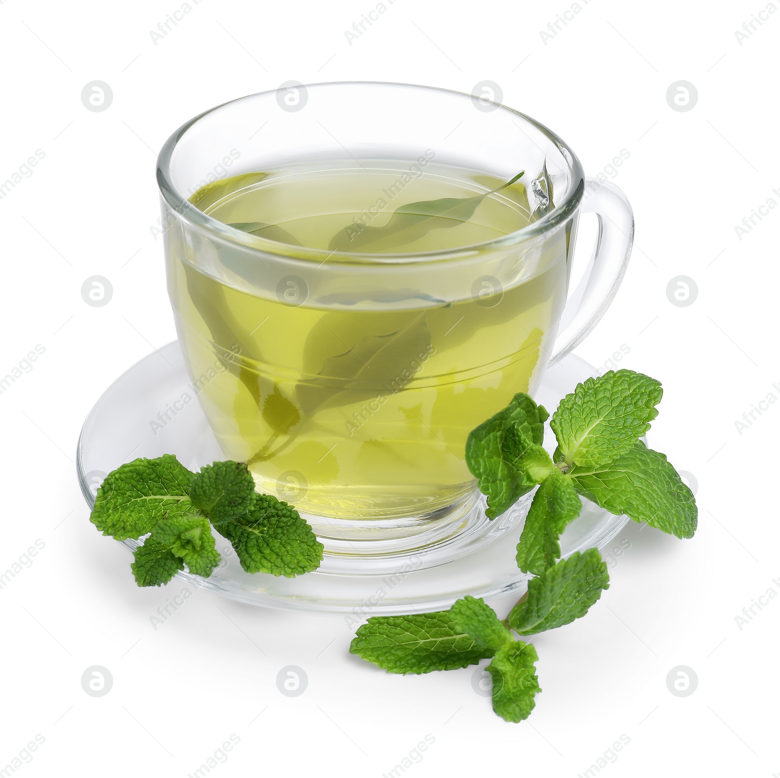 Photo of Fresh green tea in glass cup, mint and saucer isolated on white