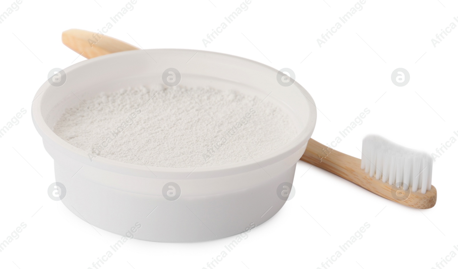 Photo of Bowl of tooth powder and brush on white background