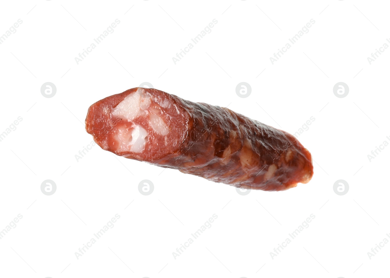 Photo of Piece of thin dry smoked sausage isolated on white