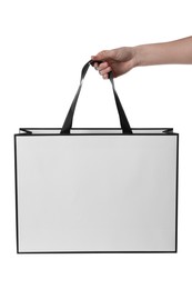 Woman holding paper bag on white background, closeup. Mockup for design