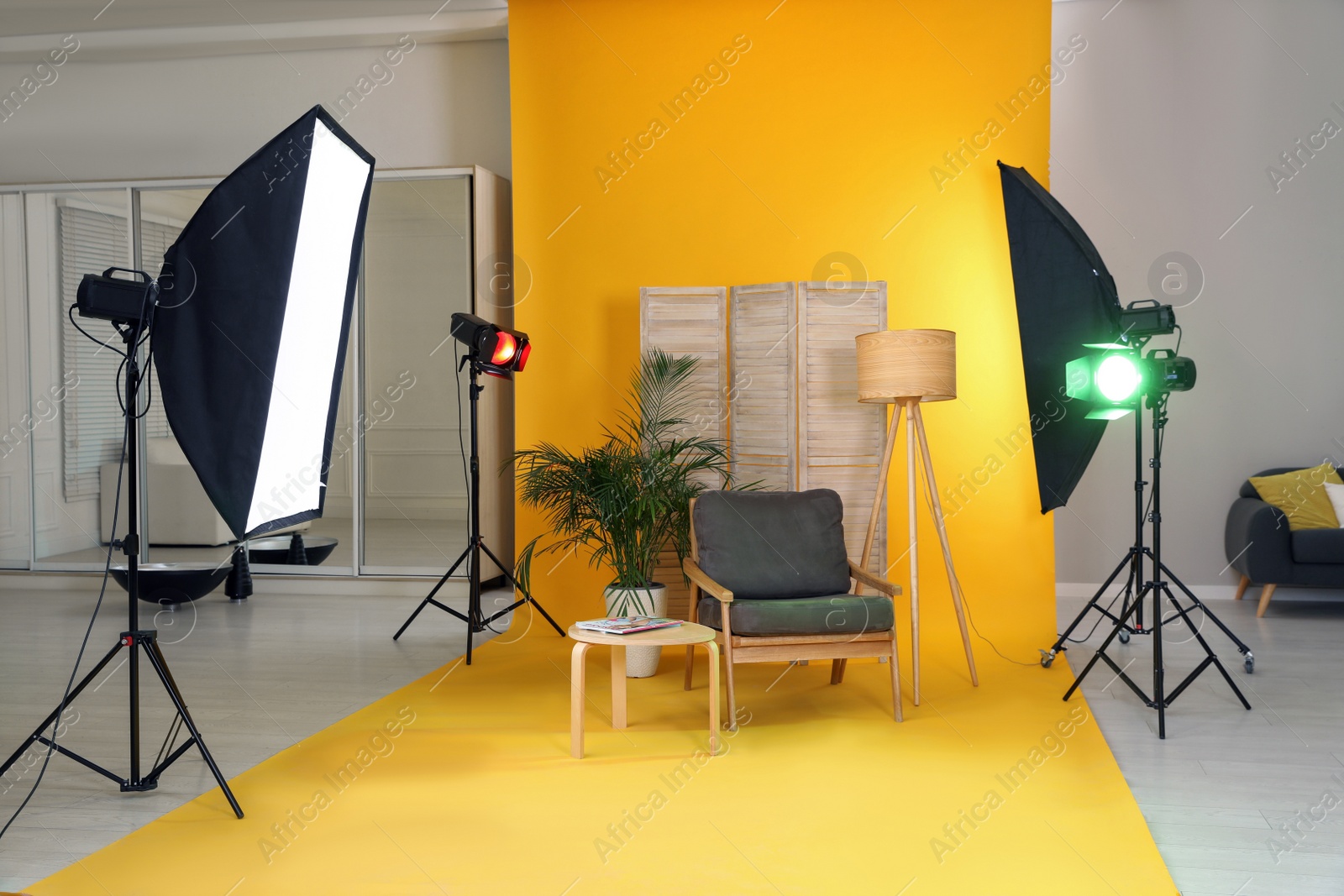 Photo of Stylish furniture in photo studio with professional equipment