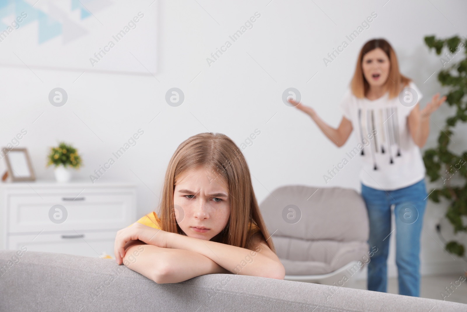 Photo of Mother scolding her teenager daughter at home