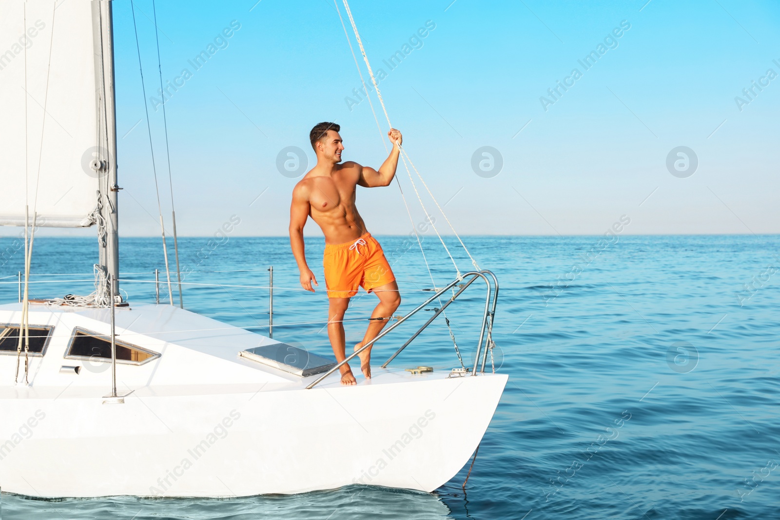 Photo of Young man relaxing on yacht during sea trip