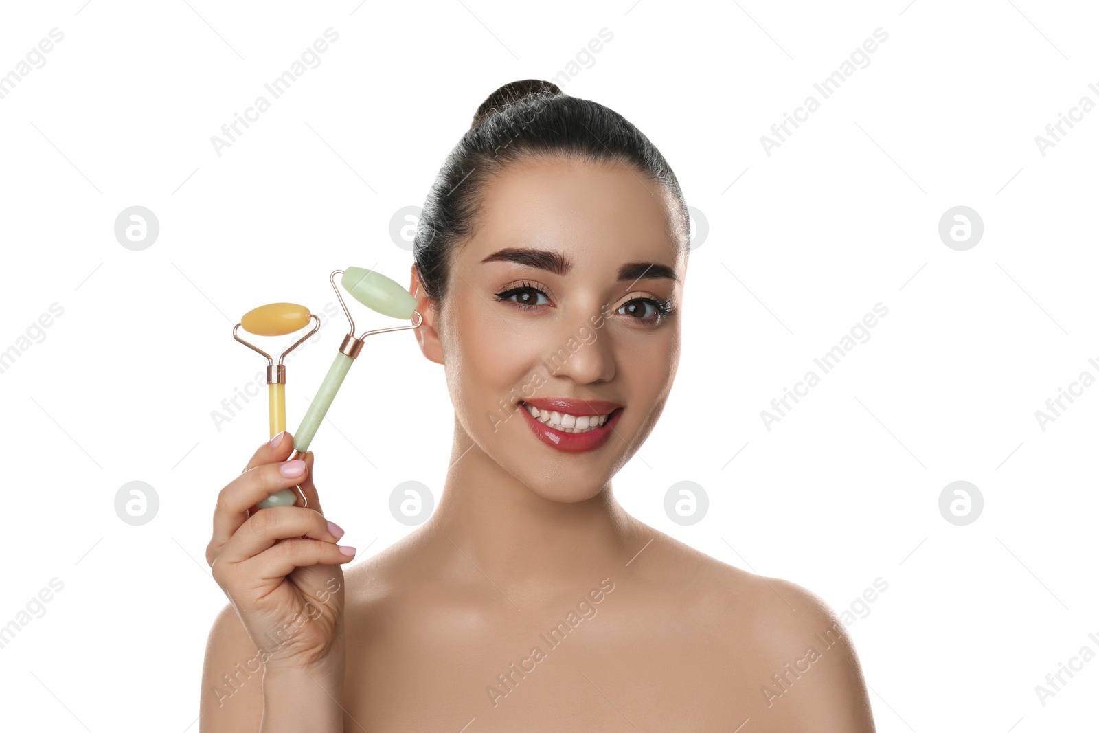 Photo of Woman with natural face jade rollers on white background