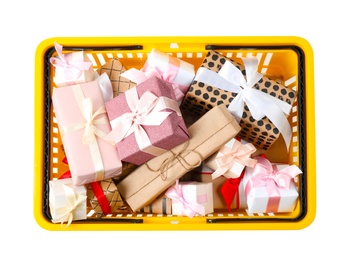 Shopping basket full of gift boxes on white background, top view