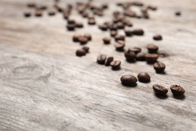 Coffee beans on wooden table, closeup