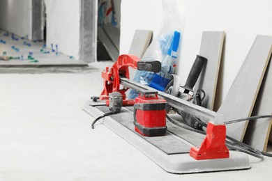 Photo of Professional tile setting equipment on floor indoors, space for text