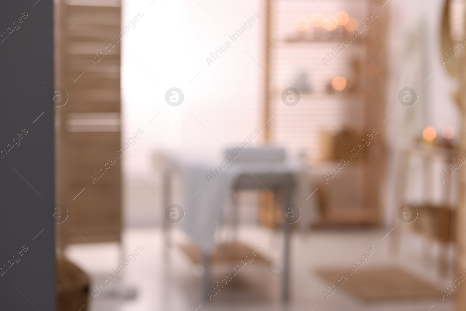 Photo of Cozy massage room with equipment, blurred view