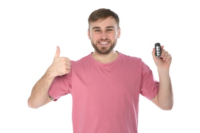 Photo of Happy young man with car key on white background. Getting driving license