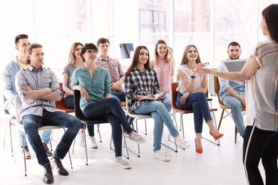 Photo of Female business trainer giving lecture in office