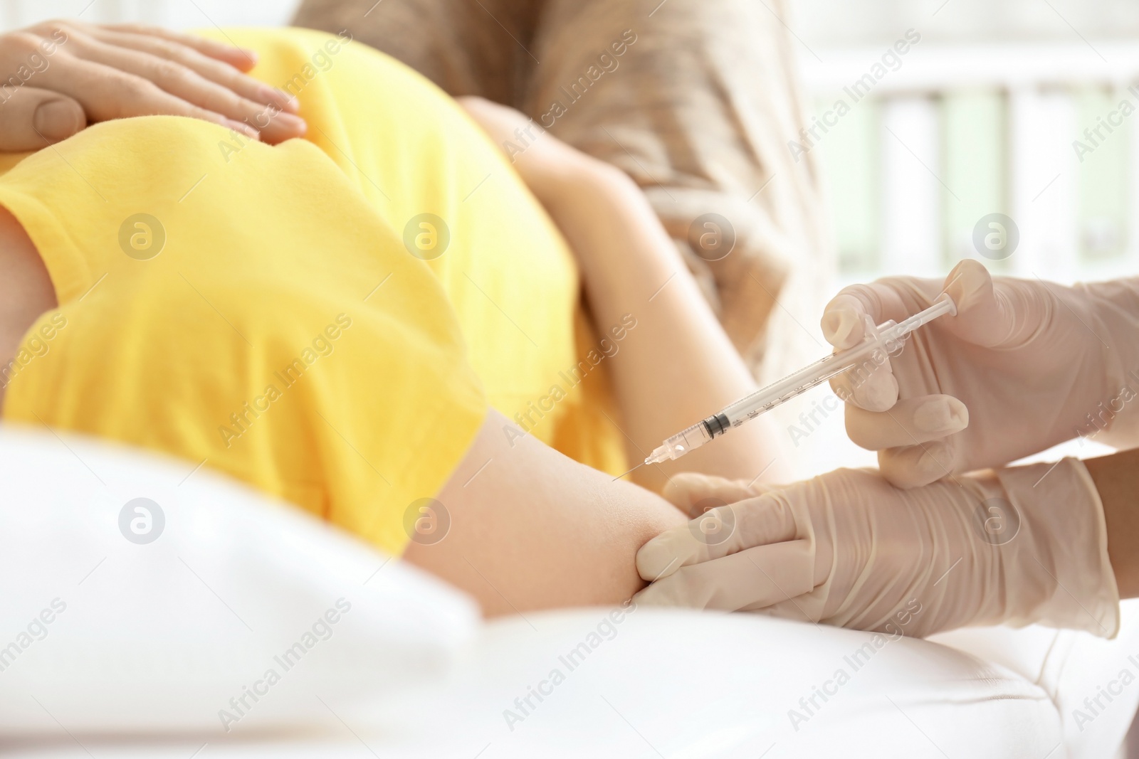 Photo of Doctor vaccinating pregnant woman in clinic