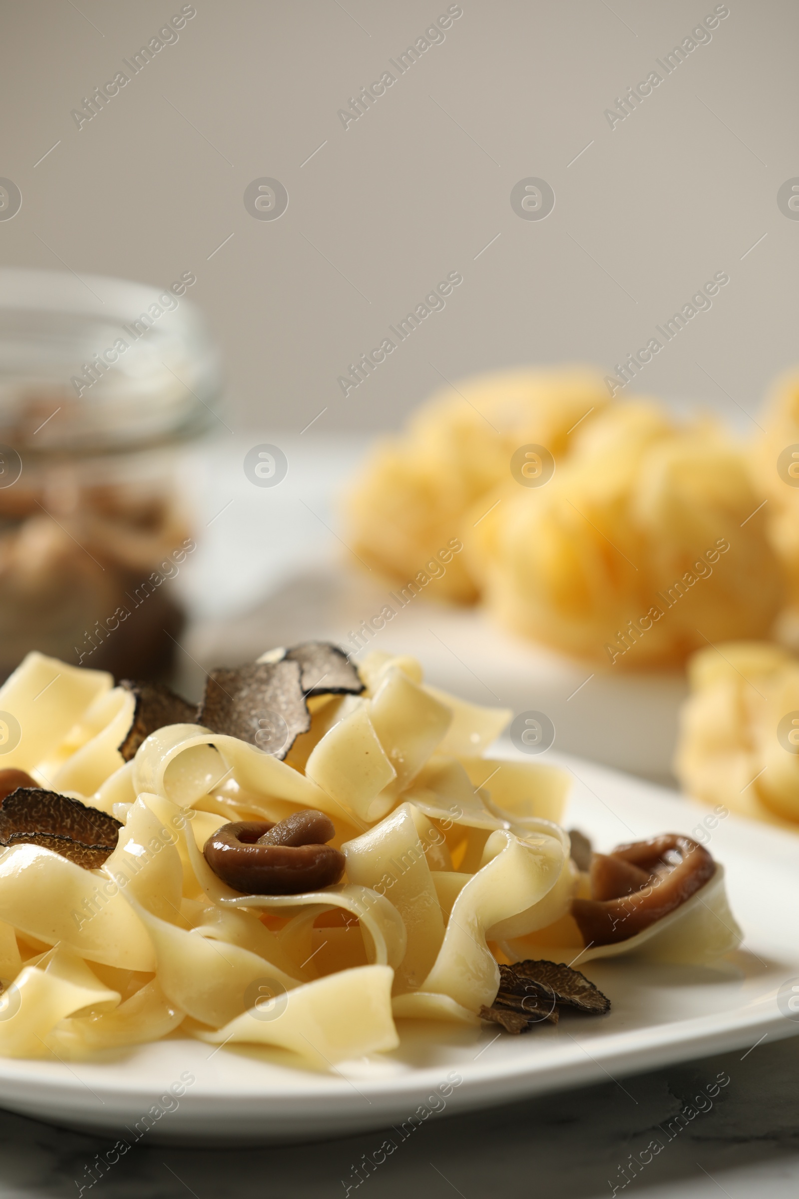 Photo of Tasty tagliatelle with truffle on table, closeup