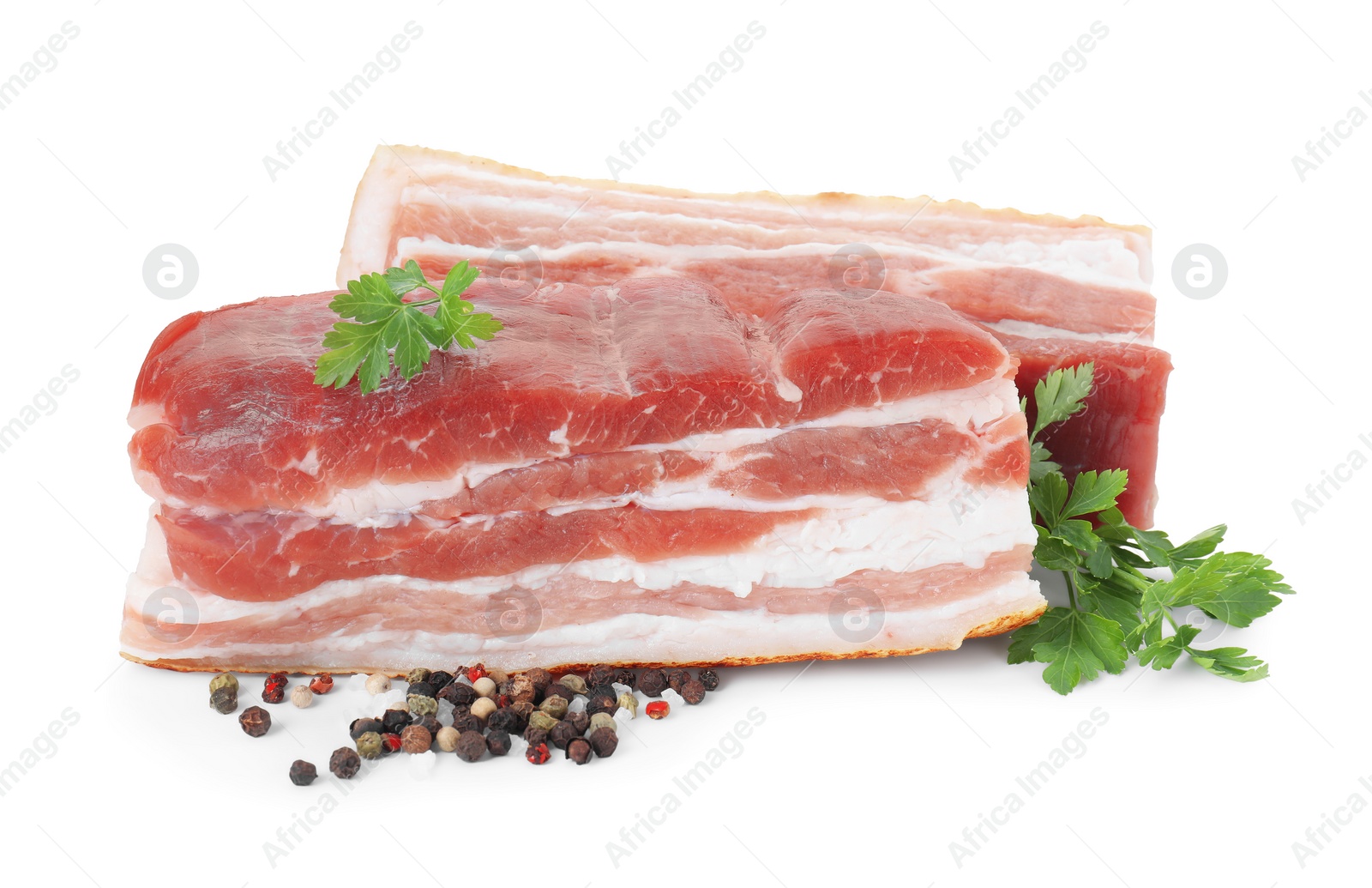 Photo of Pieces of raw pork belly, peppercorns and parsley isolated on white