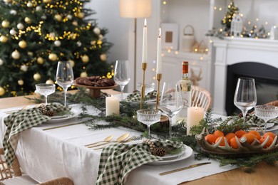 Christmas table setting with festive decor and dishware in living room