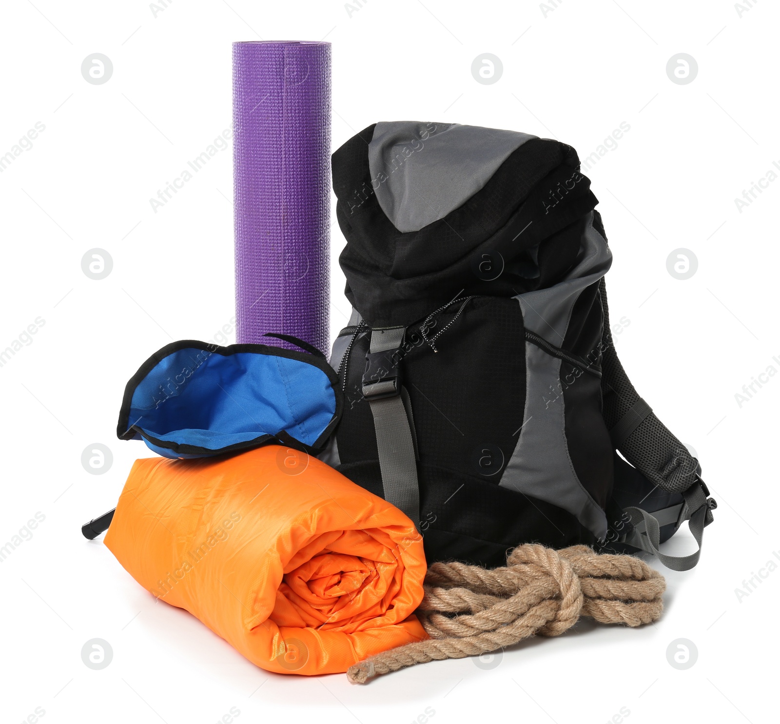 Photo of Sleeping bag, backpack and camping equipment on white background